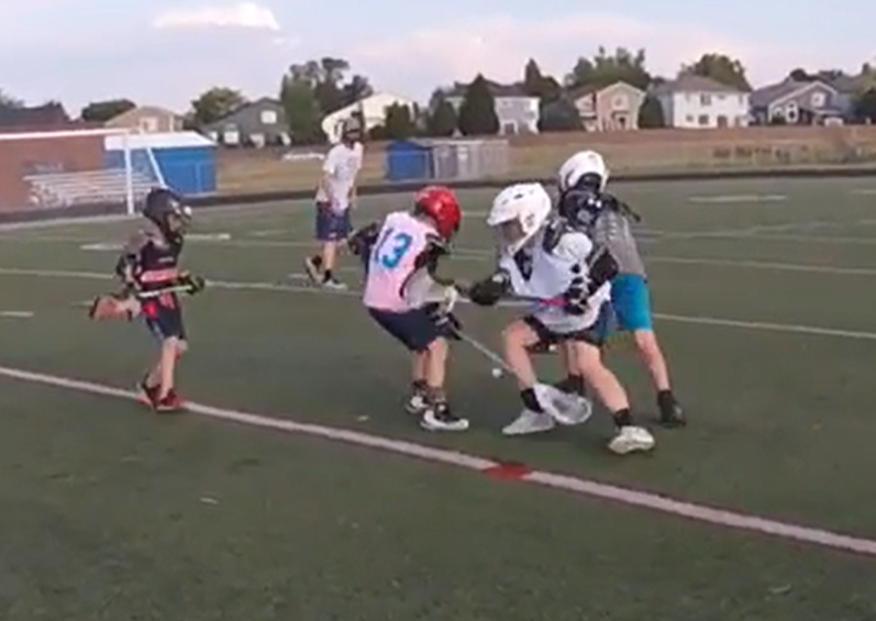 4 lacrosse campers in san antonio fighting over the ground ball at  The Summer Showdown Lacrosse Camp in San Antonio, Texas 